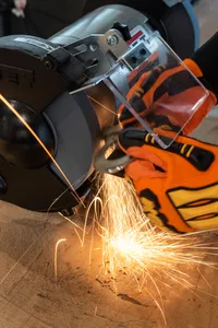 A bench grinder being used