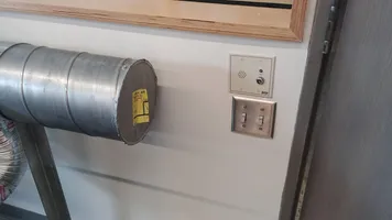 Location of the ventilation switches is behind the laser cutter closest to the door